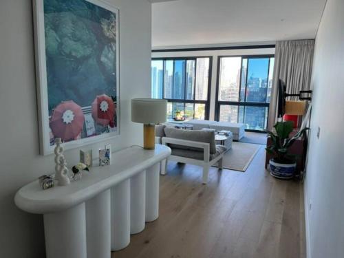 a living room with a couch and a table at New 3 Bed Penthouse Resort style complex in Brisbane