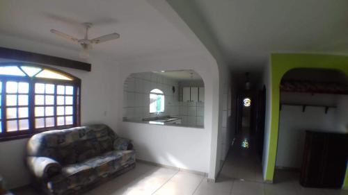 a living room with a couch and a window at Hostel Canto da Ocian in Praia Grande