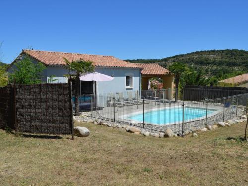 a house with a swimming pool in a yard at Charming villa with private pool near the Ard che river in Auriolles