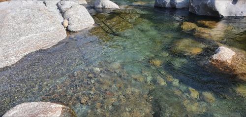 a pool of water with rocks in a river at Green Valley in Sancheong