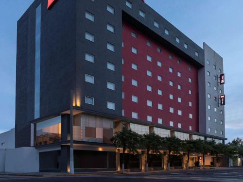 a large building with a red and black at Ibis Mexico Tlalnepantla in Mexico City