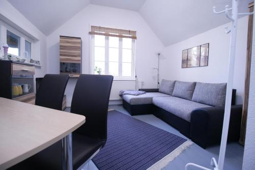 a living room with a couch and a table at Haus Koppelweg FW-Muschel in Ahrenshoop