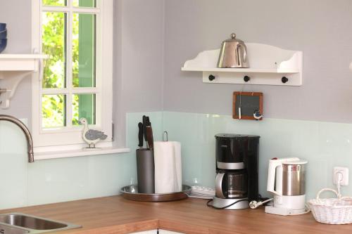 a kitchen counter with a coffee maker on a counter top at Strandnest in Wustrow