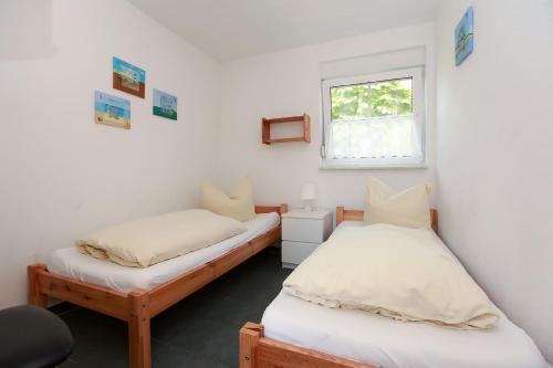 Ένα ή περισσότερα κρεβάτια σε δωμάτιο στο Haus Sanddorn Hooghass FW3