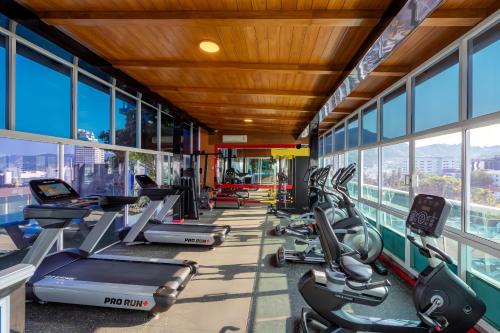 a gym with treadmills and elliptical machines at Sira Grande Hotel & Spa in Patong Beach