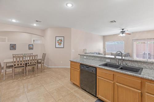 a kitchen with a sink and a table with chairs at Beautiful Spacious Single Story Vegas Home in Las Vegas
