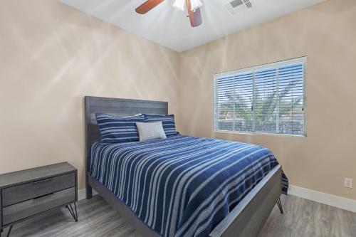 a bedroom with a bed and a window at Beautiful Spacious Single Story Vegas Home in Las Vegas