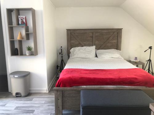 a bedroom with a large wooden bed with a red blanket at roceruzdevelopments llc in Baltimore