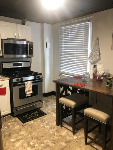 a kitchen with a stove and a table with chairs at roceruzdevelopments llc in Baltimore