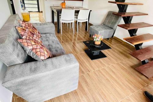 a living room with two couches and a table at Hermosa casa de campo en Barbosa in Barbosa
