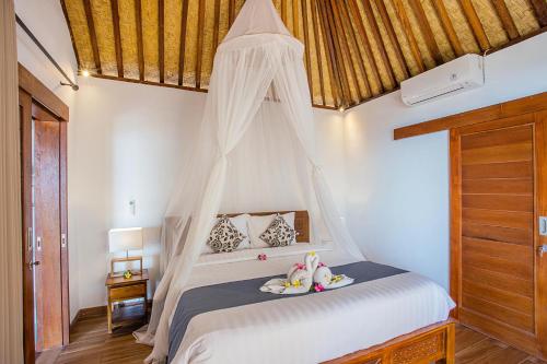 En eller flere senge i et værelse på Nusa Veranda Sunset Villas & Restaurant