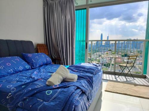 a bed in a bedroom with a view of a city at Ampang 2-4 pax Studio AmpPoint in Ampang