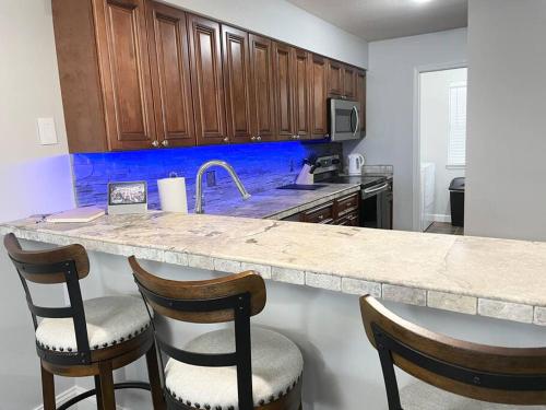 a kitchen with a counter with two chairs and a counter top at Luxury Family Condo w/ Great Views & Entertainment in Branson