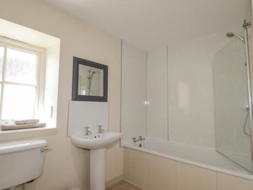 a bathroom with a sink and a toilet and a shower at East Balachladich in Muir of Ord