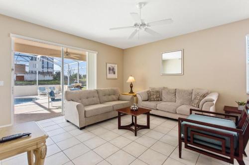 a living room with a couch and a table at Sun Living- Golf Community, Private Pool 809 villa in Davenport