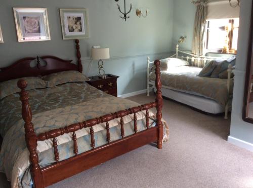 a bedroom with two beds and a window at The Swan Motel, Gillingham in Beccles