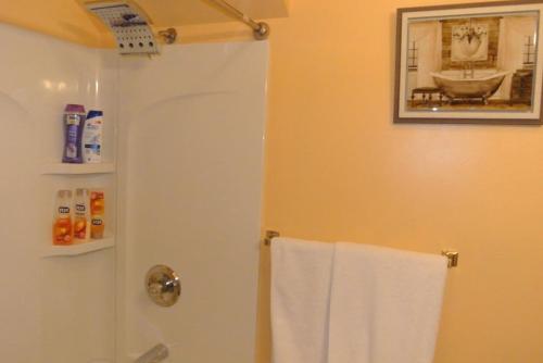 a bathroom with a shower with a white towel at Cozy Cape Cod Vacation House in Two Rivers in Two Rivers