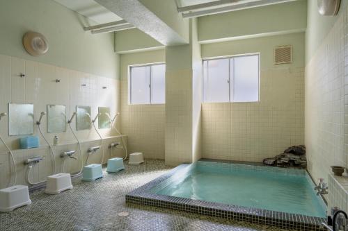 a large bathroom with a tub in the middle at Elan Hotel Lake Nojiri in Shinano