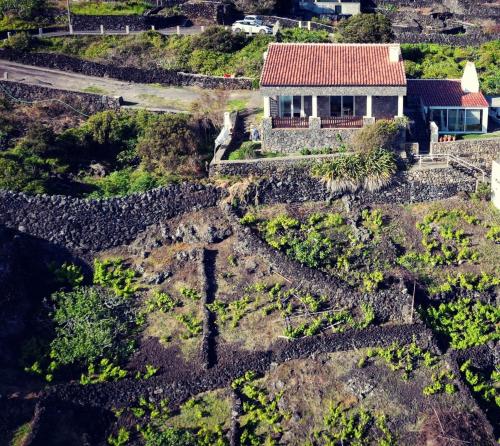 an aerial view of a house on a mountain at Breathe Nature - Beach House Azores in Feteira