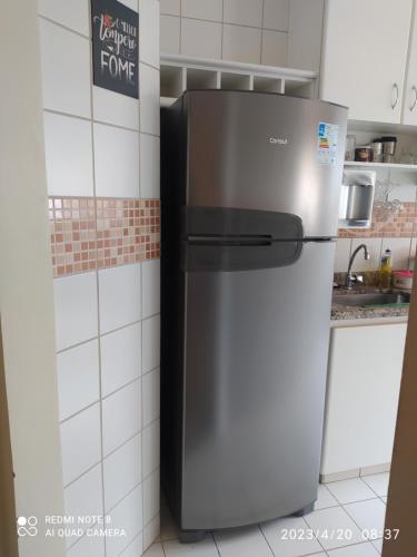 a stainless steel refrigerator in a kitchen at Privê das Thermas 01 - Ar Split nos 2 quartos, ventilador na sala, purificador Soft gelada natural in Caldas Novas