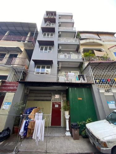 a building with a red door and a green garage at Lavendrata III in Phnom Penh