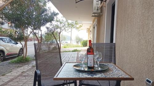 a bottle of wine sitting on a table with glasses at Angela's Seaside Luxury Flat in Lefkandi Chalkidas