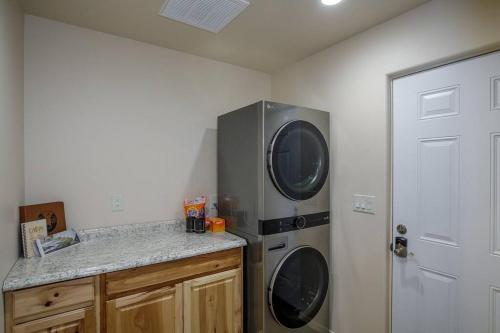 a kitchen with a refrigerator and a washer and dryer at Cozy Cub Cabin, brand new home near Yosemite in Mariposa