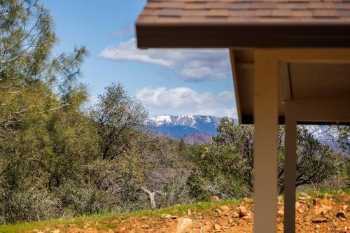 a view of a snow covered mountain from a house at Cozy Cub Cabin, brand new home near Yosemite in Mariposa