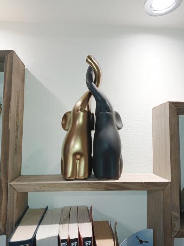 a statue of a penguin sitting on a shelf at Angela's Seaside Luxury Flat in Lefkandi Chalkidas