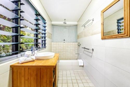 a bathroom with a sink and a shower at 'Troppo' Darwin Designer Luxury Boutique Home in Paraparap