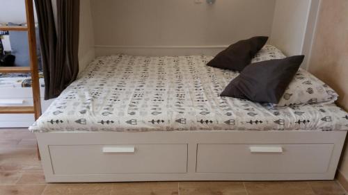 a white bed with two pillows on top of it at Rossio Studios in Lisbon