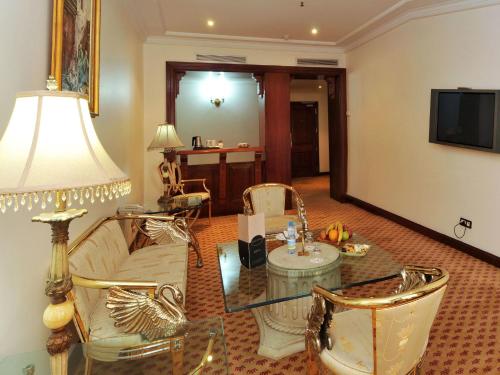 a living room with a couch and a glass table at Ramada By Wyndham Fes in Fès