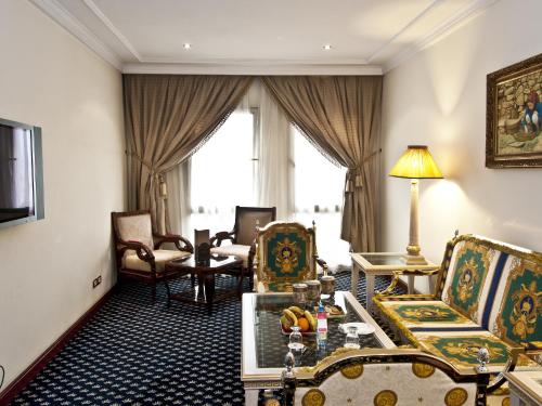a living room with chairs and a table at Ramada By Wyndham Fes in Fès