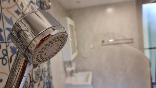 a shower head in a bathroom next to a sink at D4 The Title Residencies Naiyang Two Bedroom Phuket in Nai Yang Beach