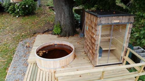 a wooden dog house and a bird bath on a deck at CIPRES Ecolodge & Spa in Frutillar