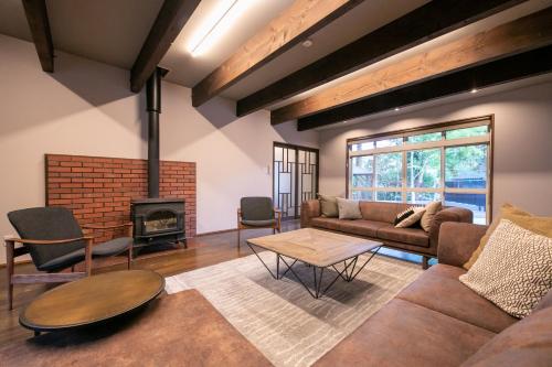 a living room with a couch and a fireplace at Oyado Ichizen in Yufuin