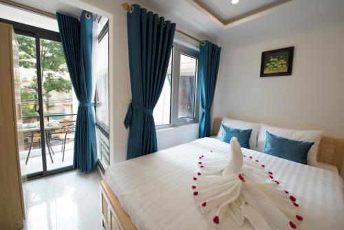 a bedroom with a bed with a flower on it at Hanoi Holiday Hotel in Hanoi