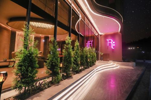 a building with a lit up sign on the side of it at Regenta Place Verka Amritsar in Amritsar