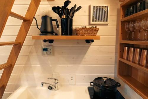 a kitchen with a sink and a pot on a stove at サウナバーベキュージャグジー完全貸し切りという贅沢大人の秘密基地#01 in Miyota
