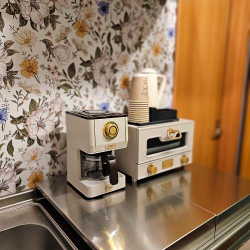 a kitchen counter with a coffee maker on top of it at ueno minowa401 in Tokyo