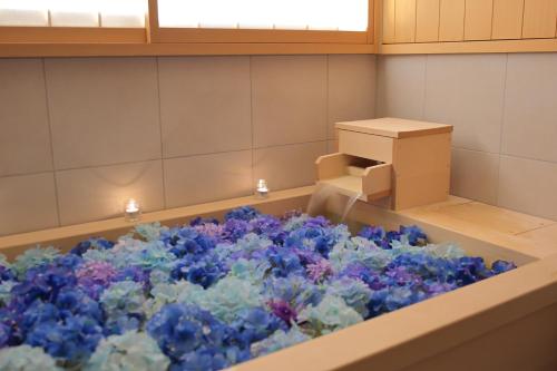 a room filled with blue flowers and a box at THE JUNEI HOTEL Kyoto in Kyoto