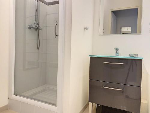 a bathroom with a shower and a sink and a mirror at Appartement Cucq-Stella Plage, 3 pièces, 4 personnes - FR-1-236-149 in Cucq