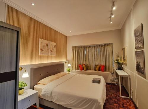 a bedroom with a large bed and a window at Casablanca Holiday Home with BBQ Pit in Kuching
