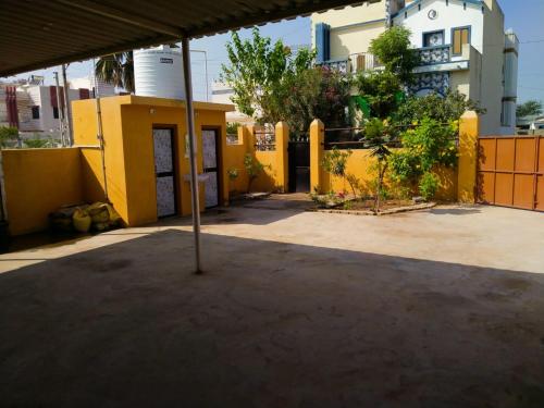 an umbrella in the middle of a parking lot at Patel's Home in Bhuj