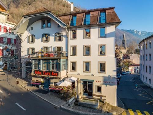 a large white building on the side of a street at Tralala Hotel Montreux in Montreux