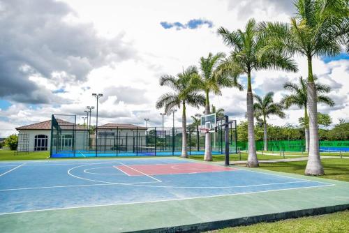 a basketball court with palm trees and a building at Laguna Lake House - Private Pool - Sleeps 12 - Elegant in Playa Blanca