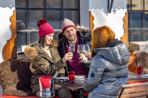 a group of people sitting around a table with wine glasses at Le Coucou Hotel Restaurant & Lounge-Bar in Montreux
