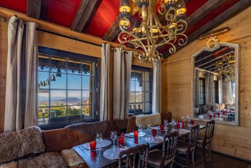 a dining room with tables and chairs and a chandelier at Le Coucou Hotel Restaurant & Lounge-Bar in Montreux