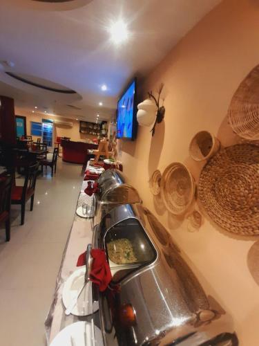 a bar in a restaurant with a motorcycle on display at Silver Mounts Hotel in Phnom Penh