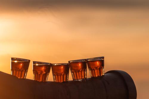 a group of glasses sitting on top of a wine bottle at Le Coucou Hotel Restaurant & Lounge-Bar in Montreux